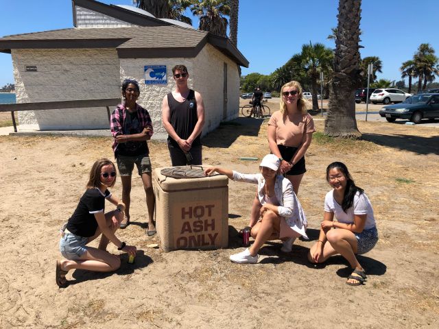 Student named Ash posing next to a hot ash disposal bin